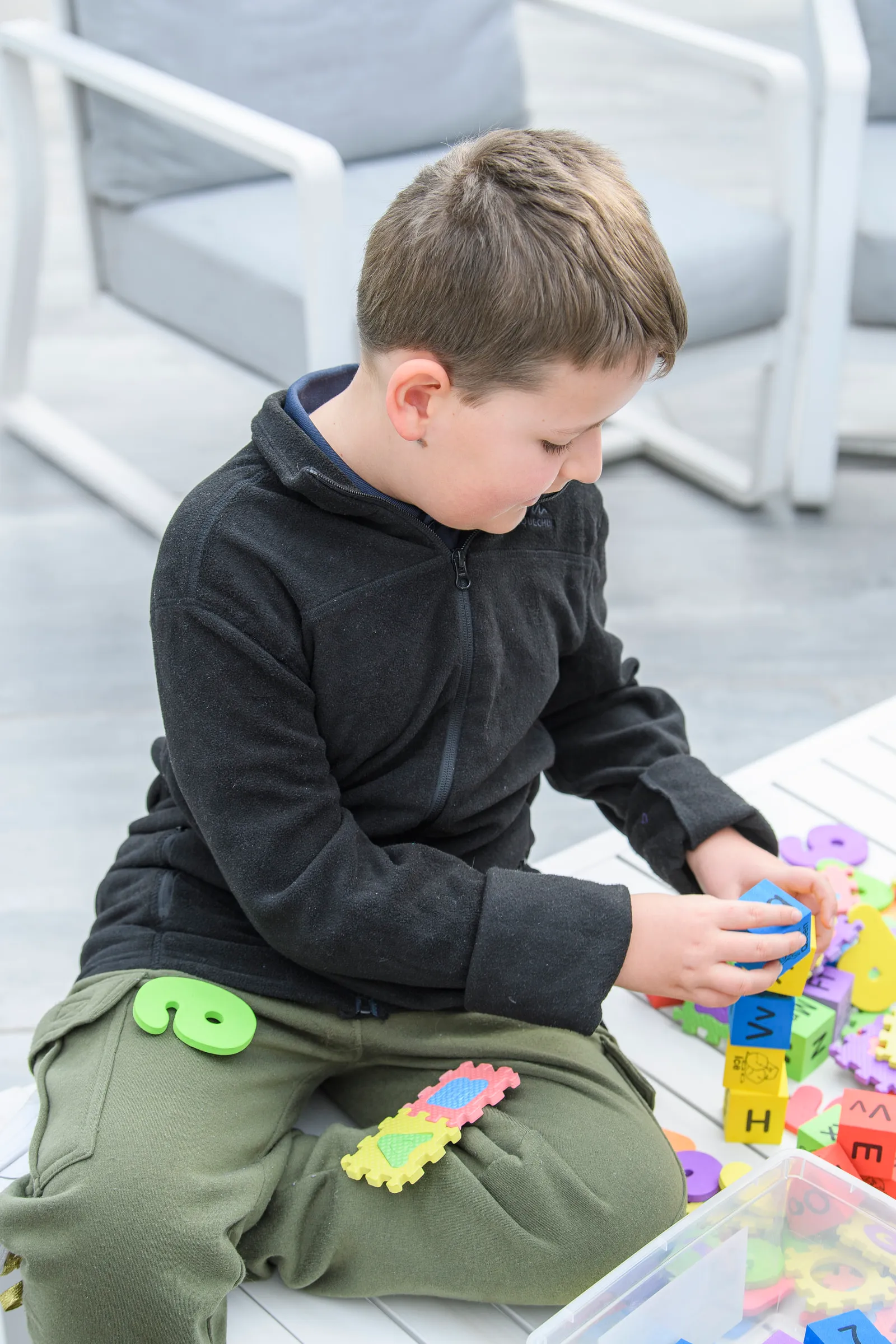 A young learner concentrating on a hands-on learning activity