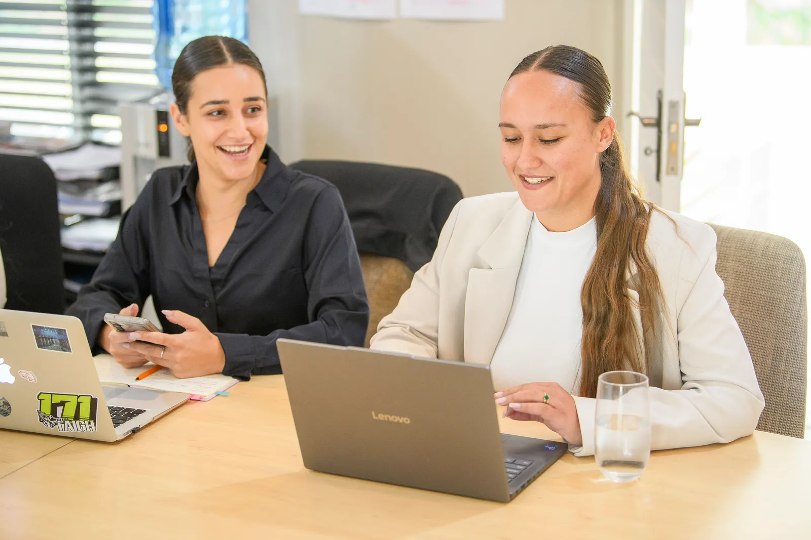 Genius colleagues collaborating and laughing together around a table