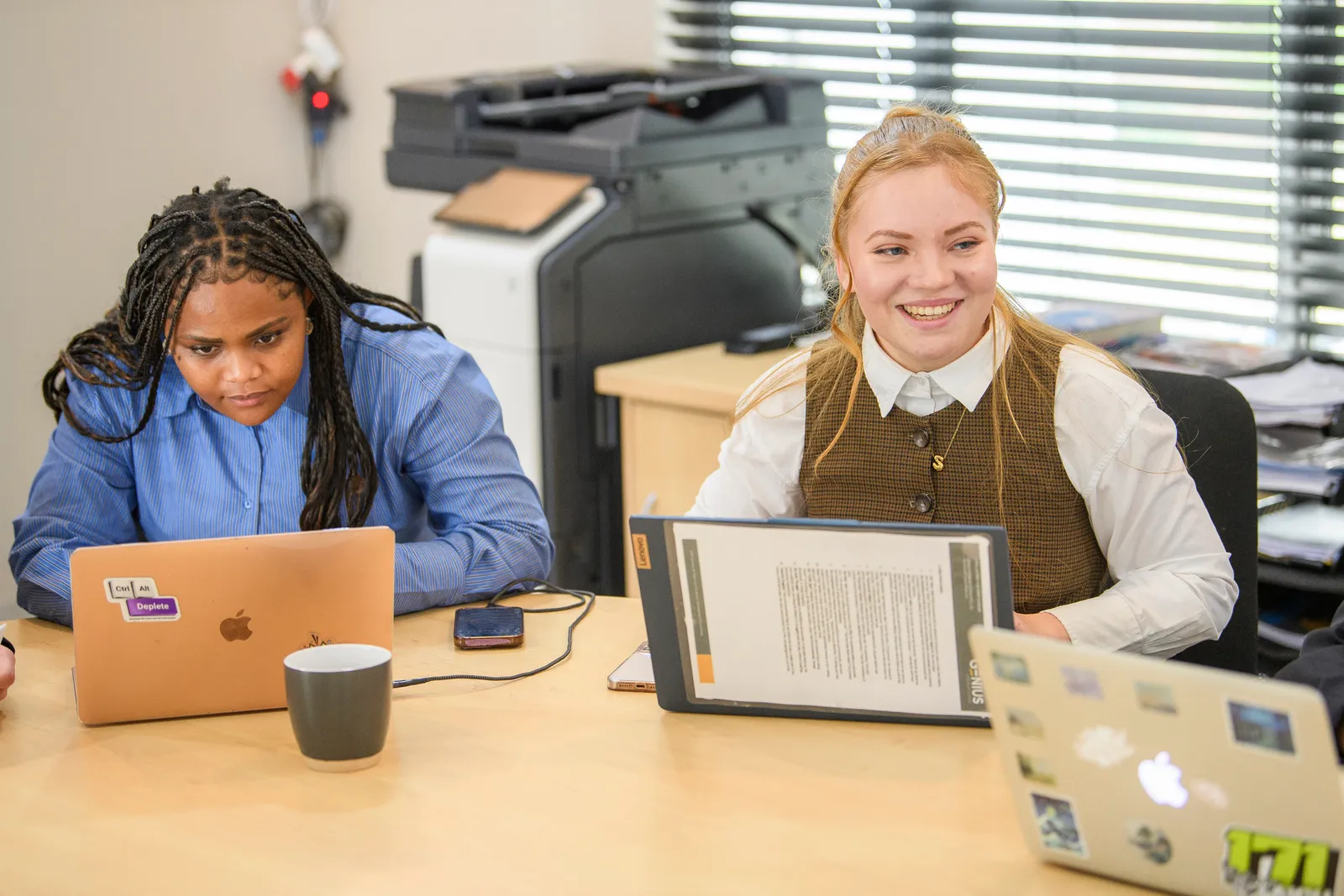 Two Genius team members working side by side
