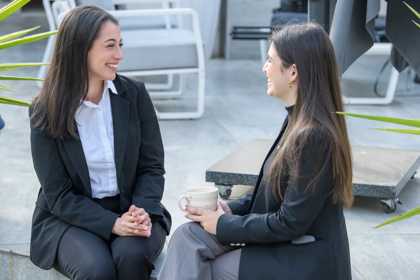 Two Genius colleagues sharing a lively conversation outdoors
